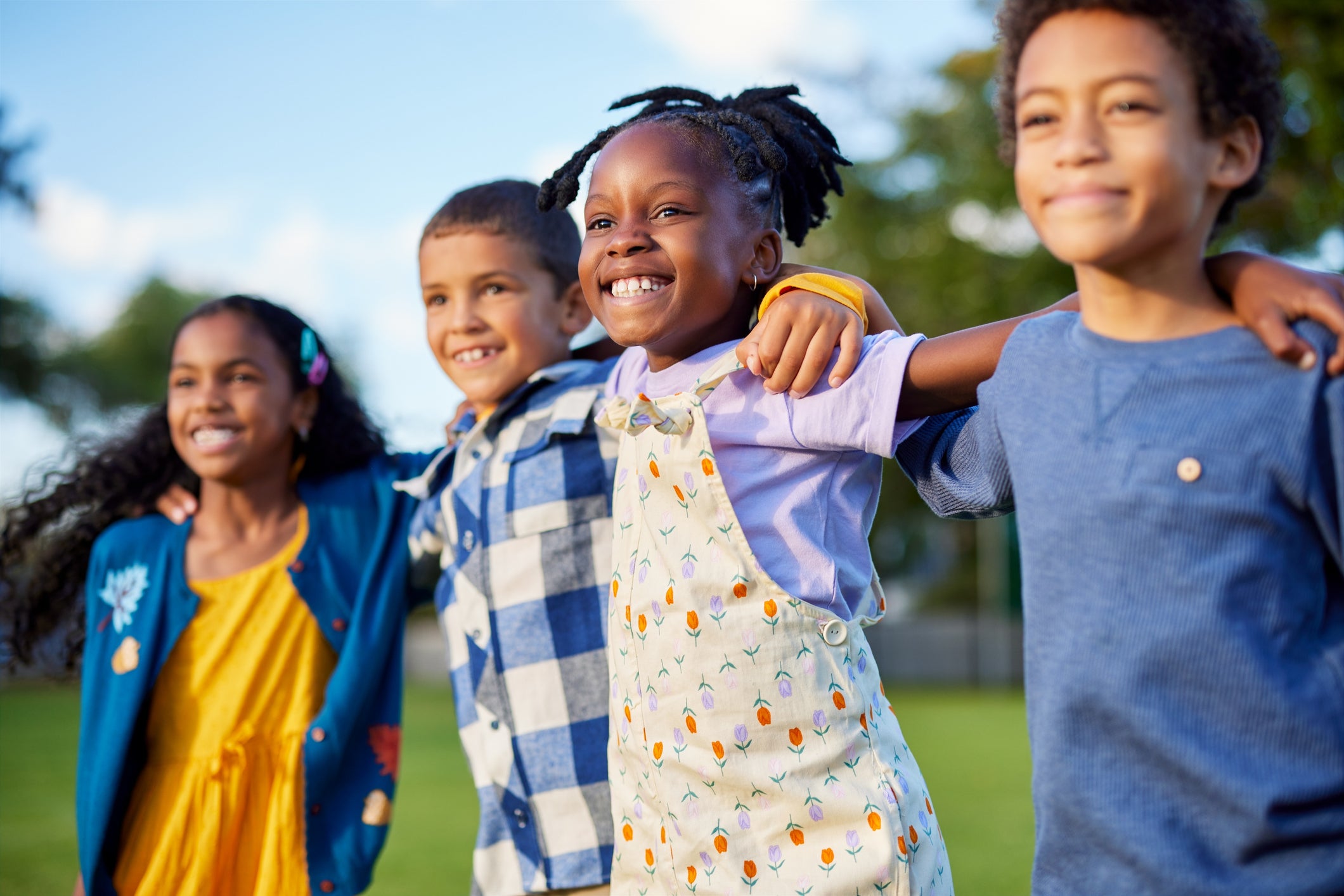 Four children outside smiling