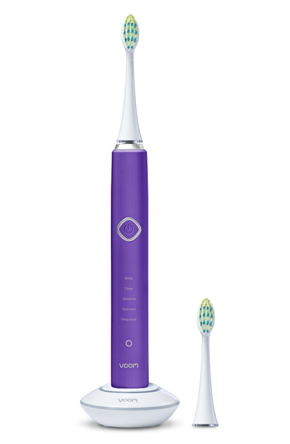 Purple electric toothbrush with a white base on a white background